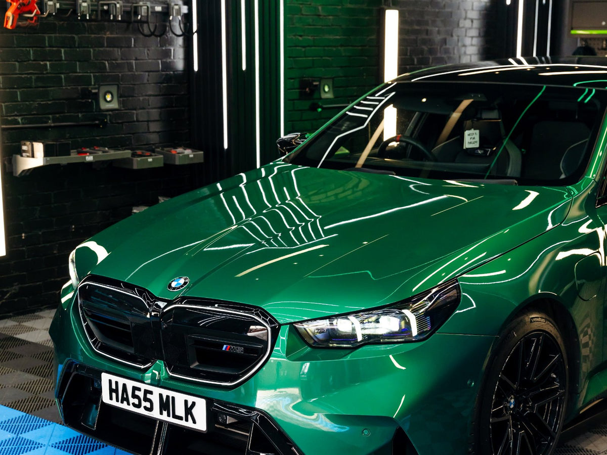 Machine polished green BMW with deep gloss in the detailing studio